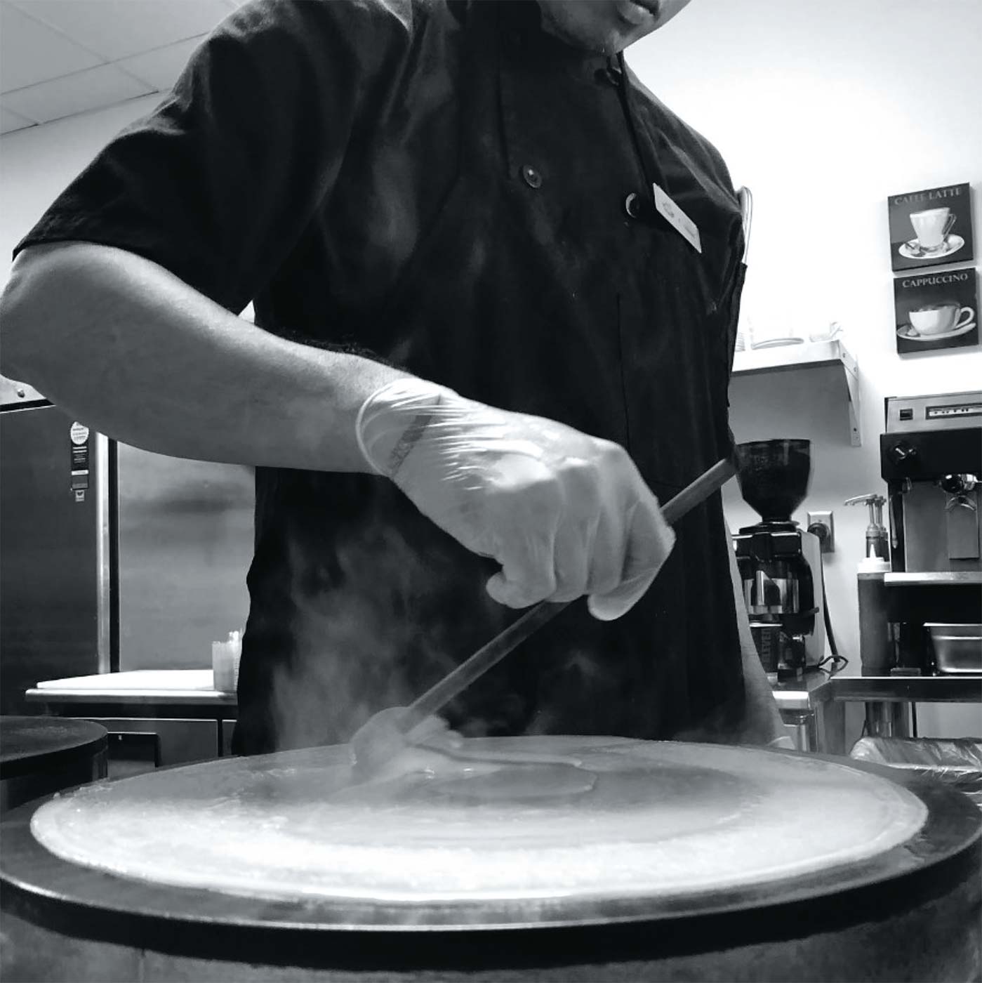 Chef Guilbert Balmaceda spreading crêpe batter on the billig at Monsieur Crêpe