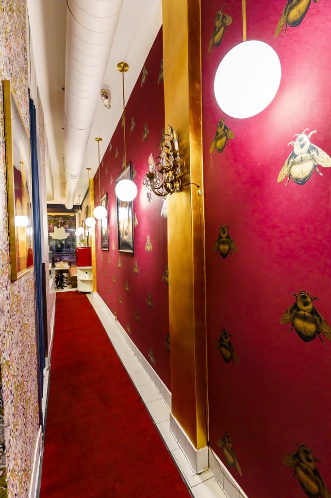 The bee wall — Napoleonic bees on burgundy, in the hallway at Monsieur Crêpe